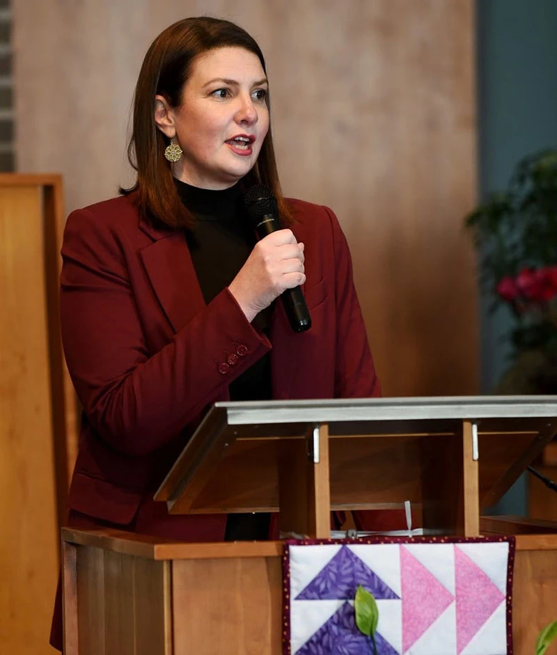 Woman speaking at podium - Legal Advocate - TurnAround